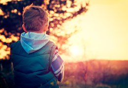 Child looking at sunset